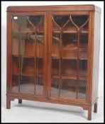 An Edwardian mahogany library bookcase cabinet raised on squared legs having twin astragal glazed