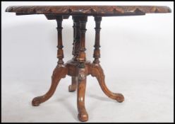 A Victorian marquetry inlaid tilt top loo / breakfast table being raised on a pedestal base with