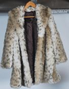 A vintage ladies hip length simulated fur coat together with a vintage 20th century  fur stole