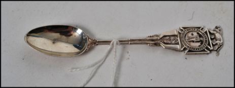An unusual silver Army Rifle Association teaspoon with decorative and oval bowl. Hallmarks for