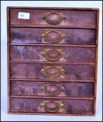 A set of vintage industrial factory table / desk top filing index cabinet drawers having a block opf
