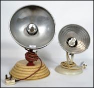 A pair of vintage / retro 20th century Barber heat lamps having a later conversion to lights
