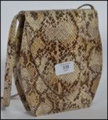 A vintage ladies snakeskin clutch bag by Rebeca Sanver with name plaque to interior.