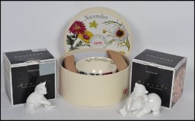 A Coalport moments polar bear and cat in white, with a Spode cup and saucer in a chrysanthemum