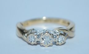 A hallmarked 9ct gold and diamond three stone ring. Hallmarked Sheffield. Size K. Weight 2.6g.