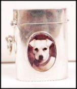 A silver barrel vesta case with an enamel pictoria