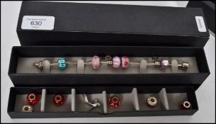 A ladies silver 925 marked charm bracelet having m