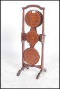 A 1920's solid mahogany 4 tier metamorphic cake stand in the manner of 'monoplane' with plaque for