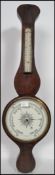 An early 20th century banjo barometer having a milk glass dial of circular form with thermometer