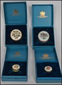 A group of four enamel pill boxes by Crummles complete in original boxes.