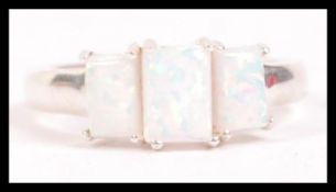 A ladies 20th century silver and opal adorned 3 st