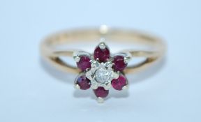 A hallmarked 9ct gold and diamond and ruby prong set cluster ring. Hallmarked London. Size O. Weight