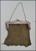 An Edwardian silver white metal mesh evening bag,  fine mesh work square bag below reticulated