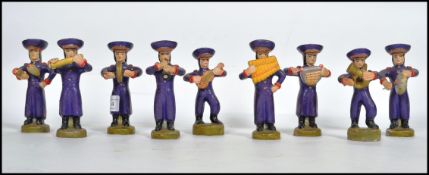 A 20th century retro vintage clay work South American nine piece marching band, the band playing