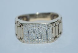 A hallmarked 9ct gold and diamond ring with channel set diamonds in a Greek key motif. Hallmarked