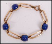 A 9ct gold / 375 and lapis Lazuli ladies bracelet being stamped Made in France to the gold lozenge