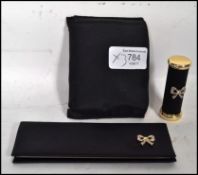 A vintage 1950s art deco style Stratton compact of gilt metal construction having a black enamel top