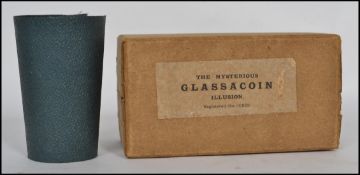 A vintage cased ' The Mysterious Glassacoin Illusion ' magic trick Reg10859. The glass and sleeve