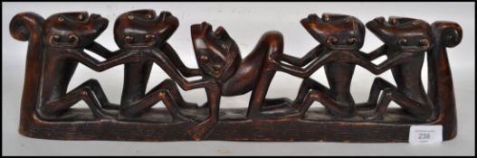 A 20th century African tribal carved hard wood totem, carved from a singular piece of wood depicting