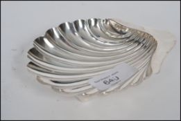 A silver hallmarked butter dish in the form of a shell being hallmarked for Henry Atkins of