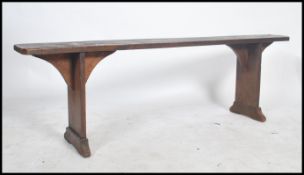 A   19th century French refectory pig bench. The bench with shaped single plant tops of fruitwood