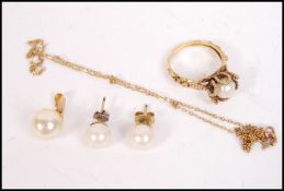 A pair of yellow metal simulated pearl earrings wi