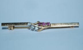 A hallmarked 9ct gold bar brooch set with white an