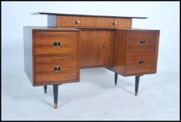 A 1970's retro teak wood G-Plan type writing table