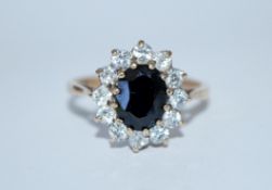 A hallmarked 9ct gold sapphire and white stone clu