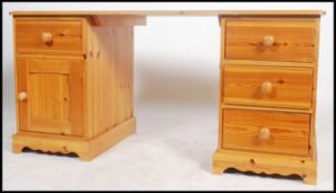A 20th century contemporary twin pedestal pine kne