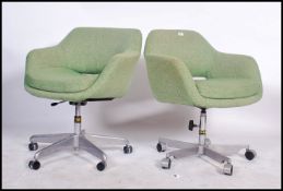 A pair of 1970's office swivel chairs in the manne
