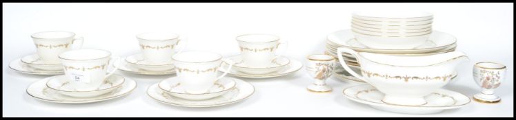 A part bone china gilt decorated on white ground d