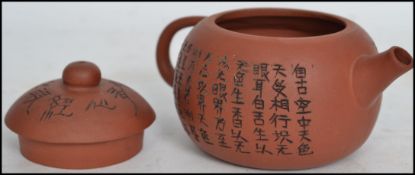 A terracotta Yixing teapot of squat globular form