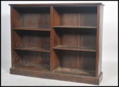 An Edwardian mahogany double open window library l