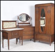 An Edwardian oak bedroom suite of furniture consisting of a marble top washstand together with a