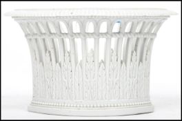 A Meissen cream basalt porcelain planter vase having pierced sides with ribbed edge and blue cross