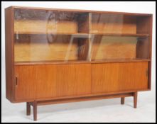 A vintage 20th century retro danish influence G-Plan style teak wood display cabinet raised on