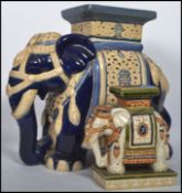A Chinese 20th century ceramic elephant plant stand in blue and white colourway together with a