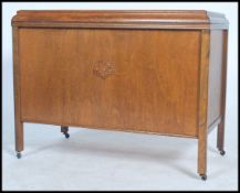 An early 20th century wooden blanket box raised on square legs with hinged lid opening to reveal a