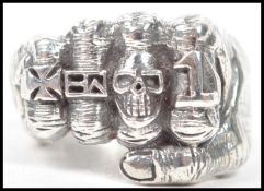 An unusual 20th century / contemporary brutalist ring in the form of a fist set to a plain shank