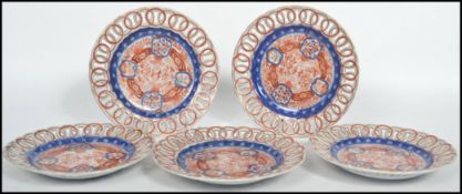 A collection of five circa 1900's Japanese  Imari patterned, each plate having a ribbon edge /