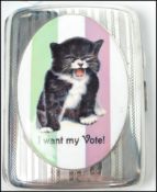 A good silver cigarette case with an enamel plaque of a cat in the suffragette manner bearing