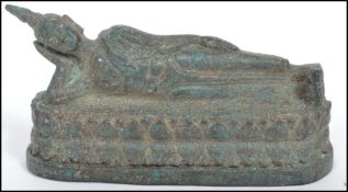 A 19th century bronze Buddha modelled in a reclined position raised on a oval plinth base.