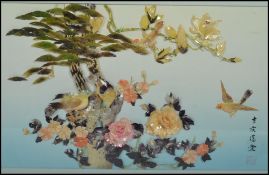 A 20th century framed and glazed Japanese Shibayama work depicting birds, trees and flowers set in
