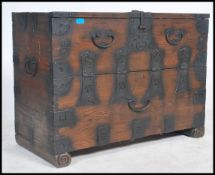 A  good early 20th century Chinese campaign style hardwood chest, having a hinged top with