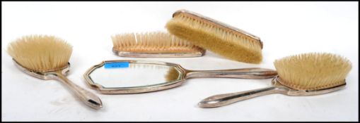 A mid 20th century silver hallmarked five piece dressing table set by Mappin and Webb consisting