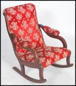 A Victorian mahogany rocking chair / armchair being raised on sleigh runners with sabre legs and