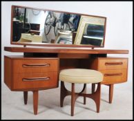 A 1970's retro teak wood G-Plan Kelso dressing table having pedestals of drawers raised over tapered