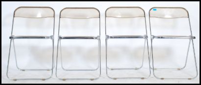 A set of four retro 20th century Plia perspex and chrome folding chairs designed by Giancarlo