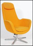 An egg chair style swivel chair having an atomic space age form in yellow raised on a metal star